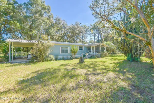 a view of a house with pool and tree s
