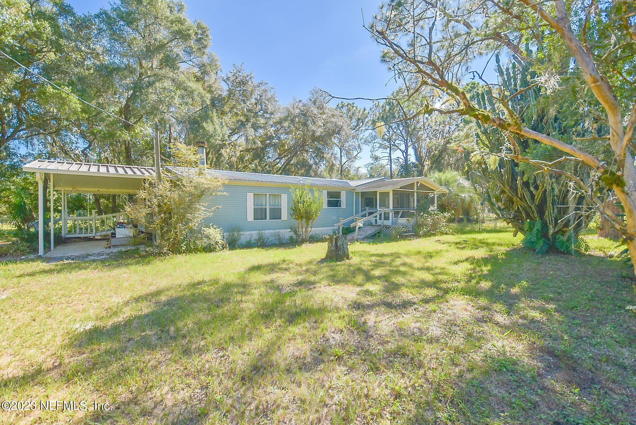 a view of a house with pool and tree s