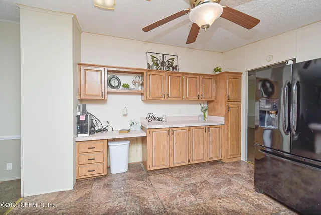 a kitchen with stainless steel appliances a stove refrigerator and cabinets