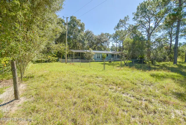 a view of yard with large trees