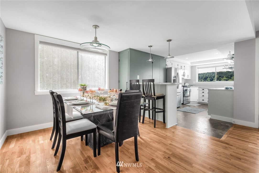 6417 Ripley Ln S East Renton, WA 98056 - Photo 11 of 39 a view of a dining room with furniture window and wooden floor