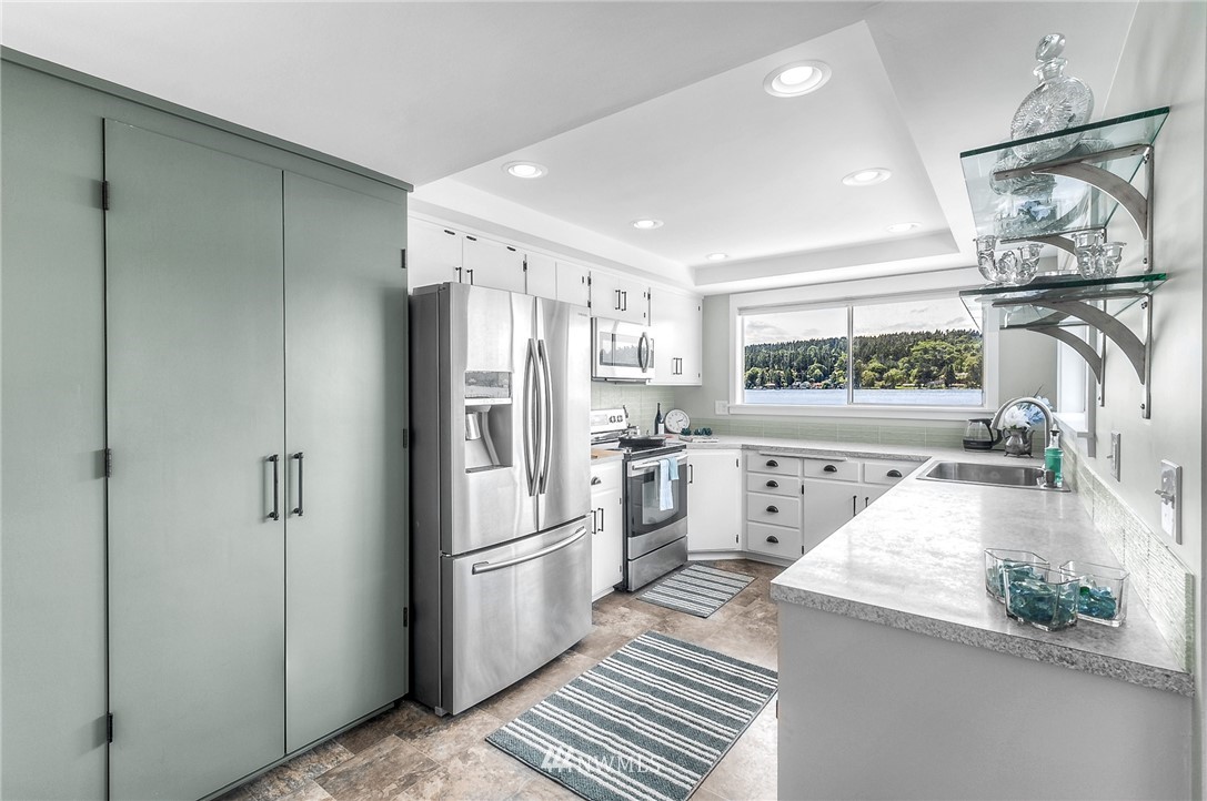 6417 Ripley Ln S East Renton, WA 98056 - Photo 12 of 39 a kitchen with a refrigerator and a sink