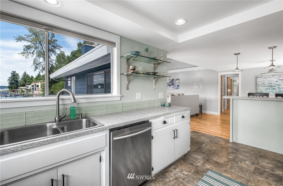 6417 Ripley Ln S East Renton, WA 98056 - Photo 18 of 39 a kitchen with white cabinets and appliances