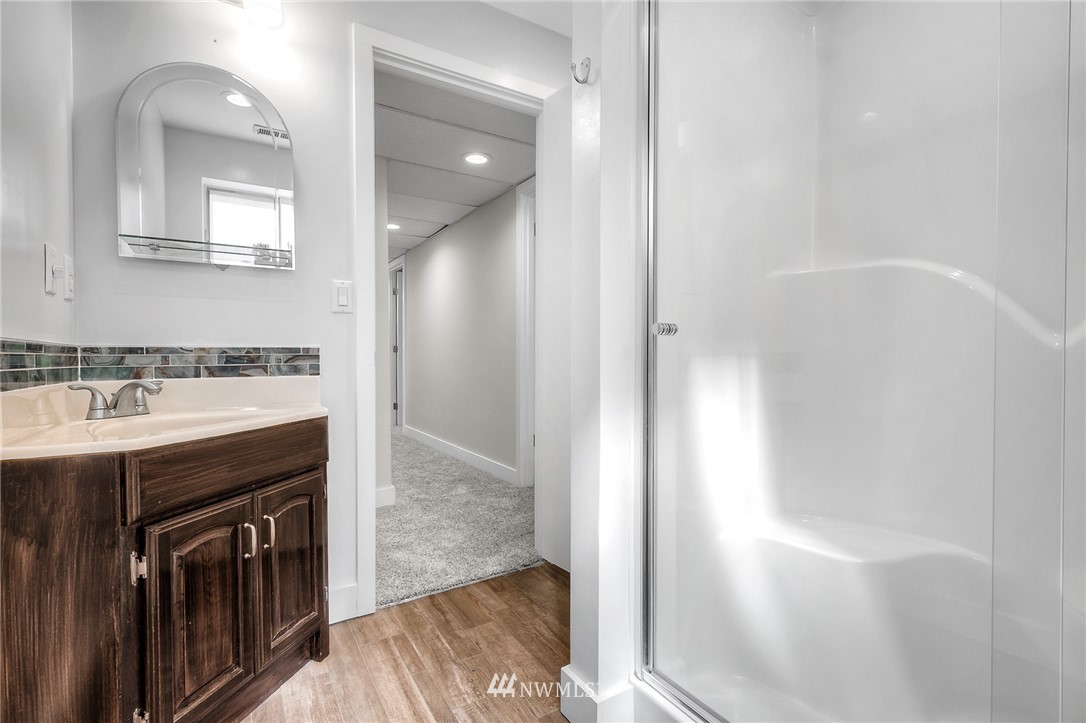 6417 Ripley Ln S East Renton, WA 98056 - Photo 27 of 39 a spacious bathroom with a sink a mirror and a shower