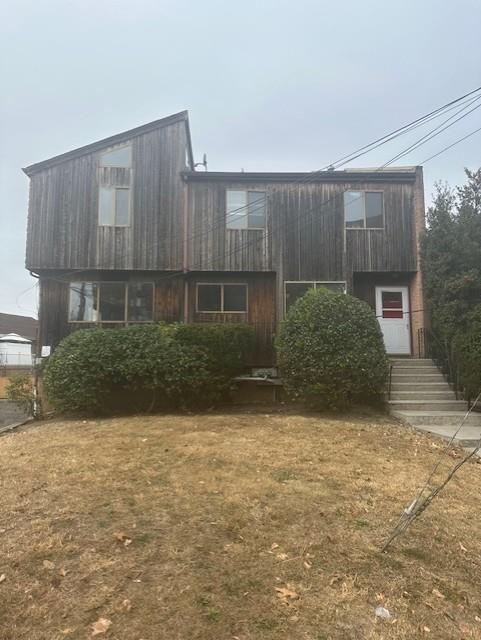 a view of backyard with potted plants and wooden fence