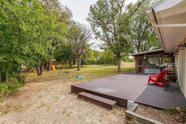 a view of a yard with wooden deck