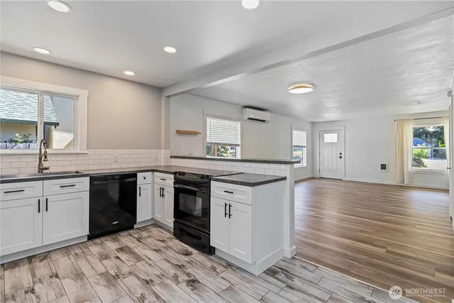 a kitchen with stainless steel appliances granite countertop a stove and a sink