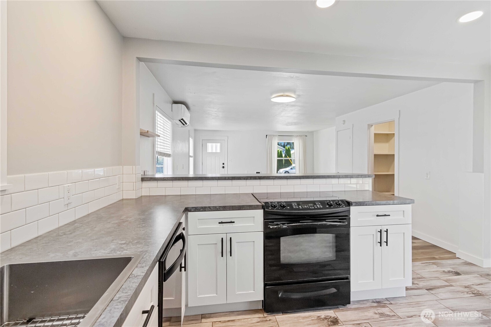 753 Southeast Sumner Street Camas, WA 98607 - Photo 15 of 37 a kitchen with granite countertop a stove and a sink