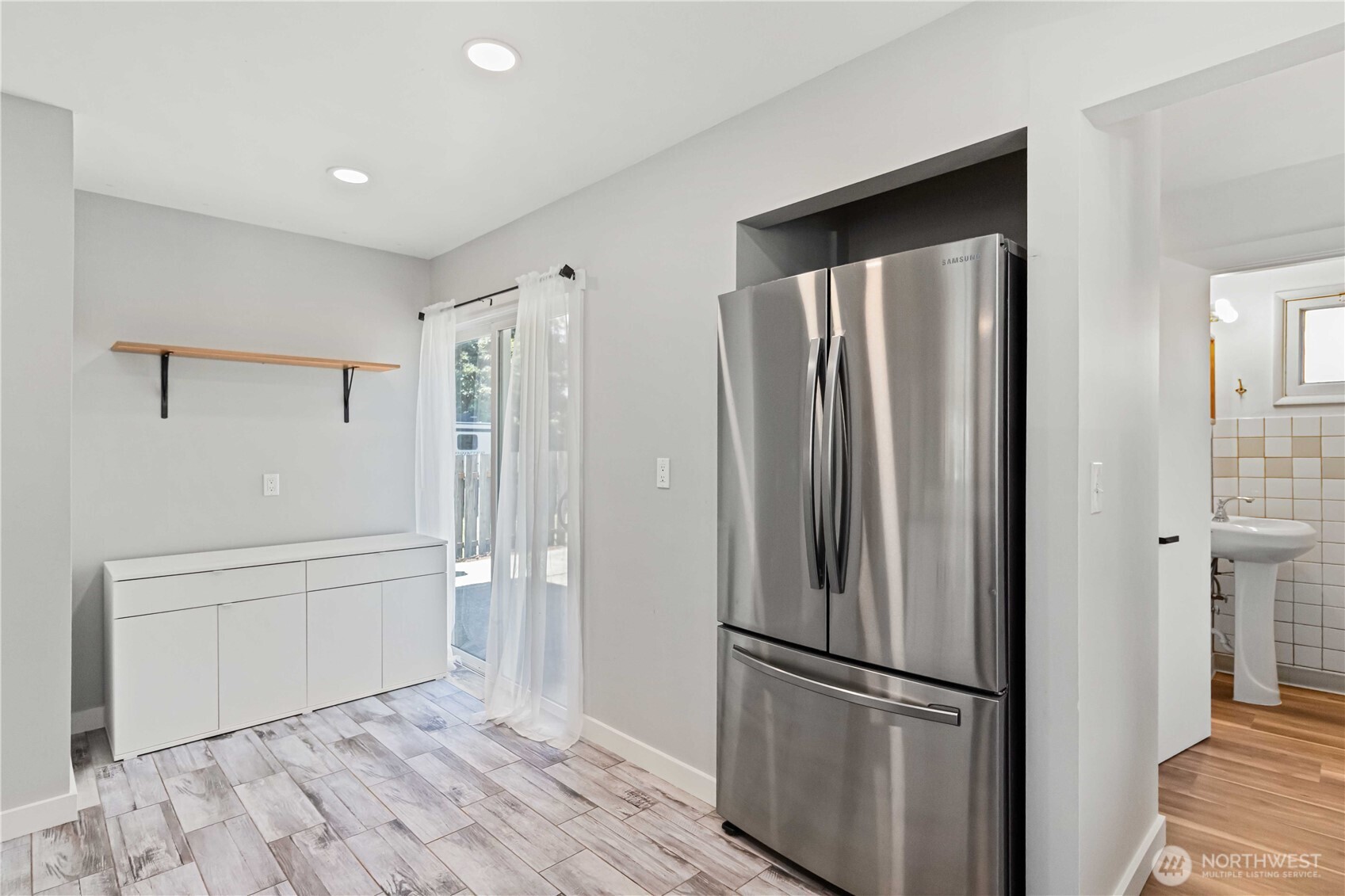 753 Southeast Sumner Street Camas, WA 98607 - Photo 16 of 37 a view of a kitchen with a refrigerator and wooden floor