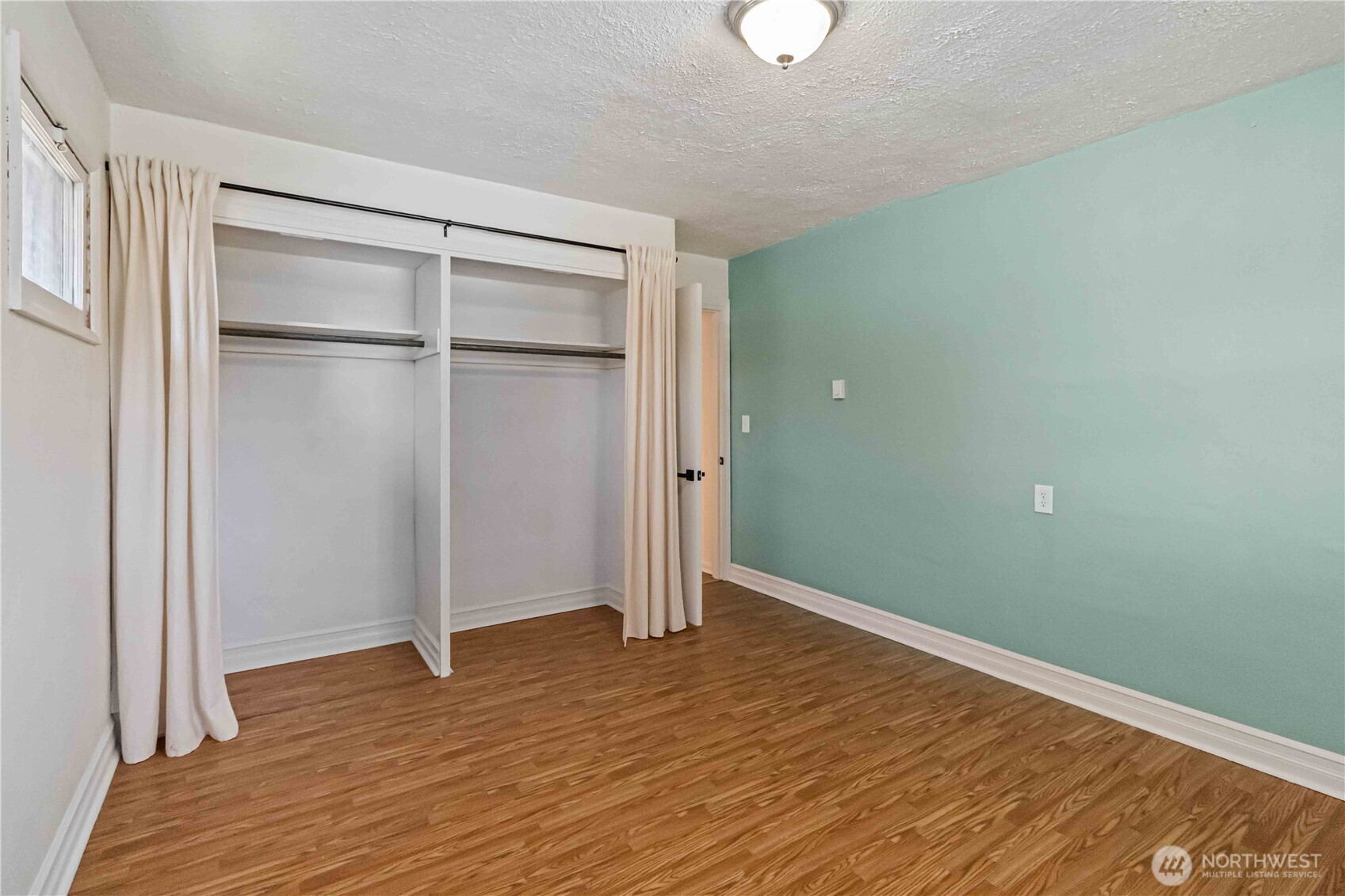 753 Southeast Sumner Street Camas, WA 98607 - Photo 19 of 37 a view of an empty room with wooden floor