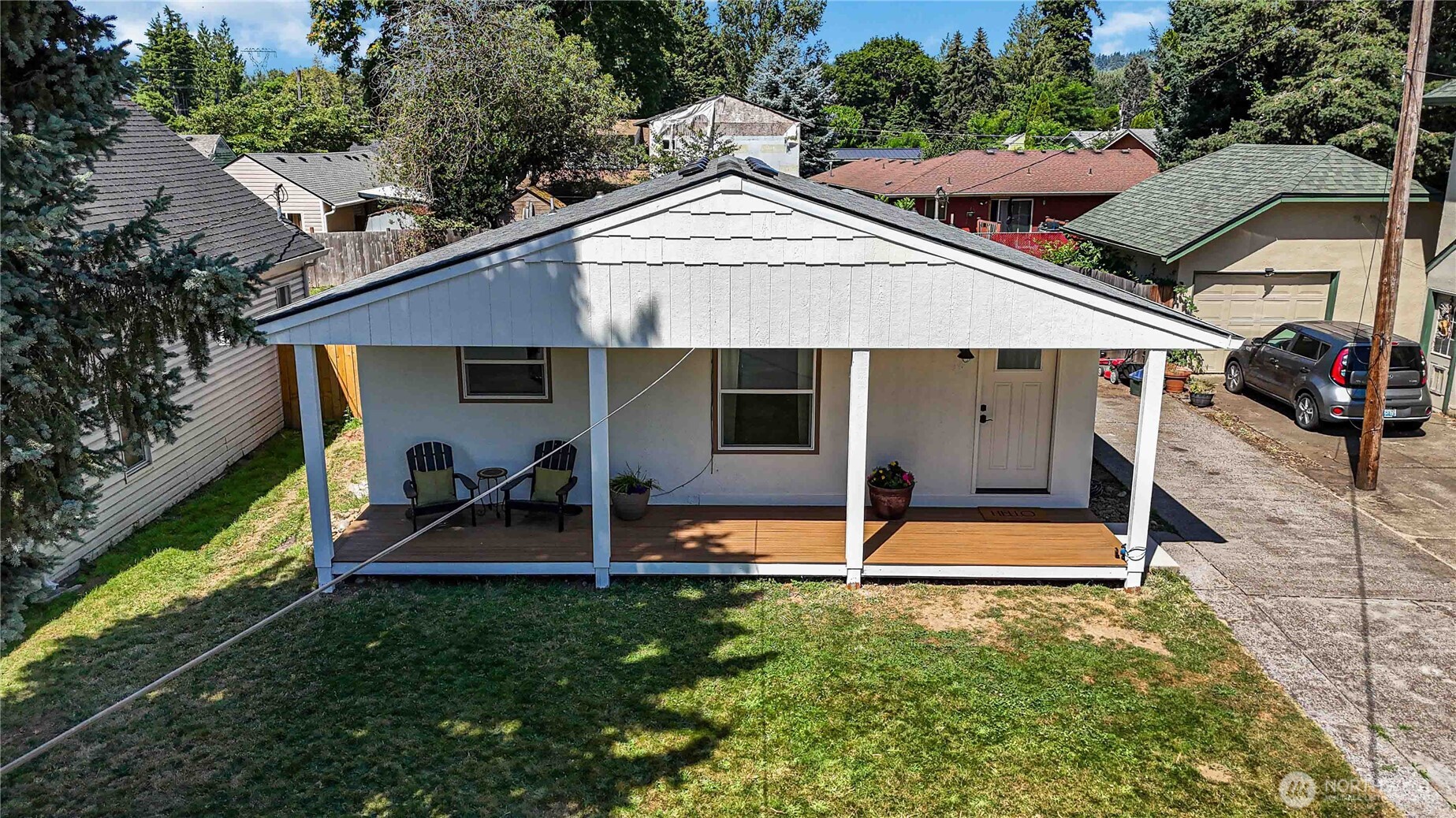 753 Southeast Sumner Street Camas, WA 98607 - Photo 29 of 37 a front view of a house with a yard table and chairs under an umbrella