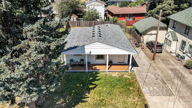 an aerial view of a house with swimming pool and porch