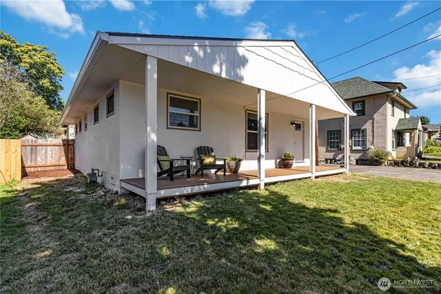 a view of a house with backyard porch and sitting area