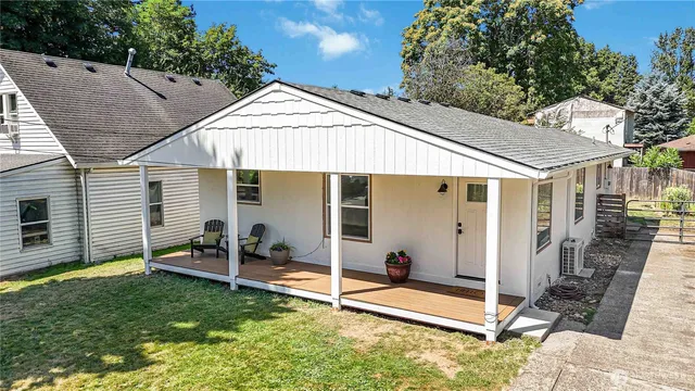 a backyard of a house with table and chairs