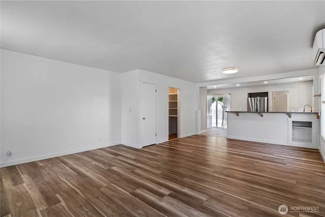 a view of empty room with wooden floor