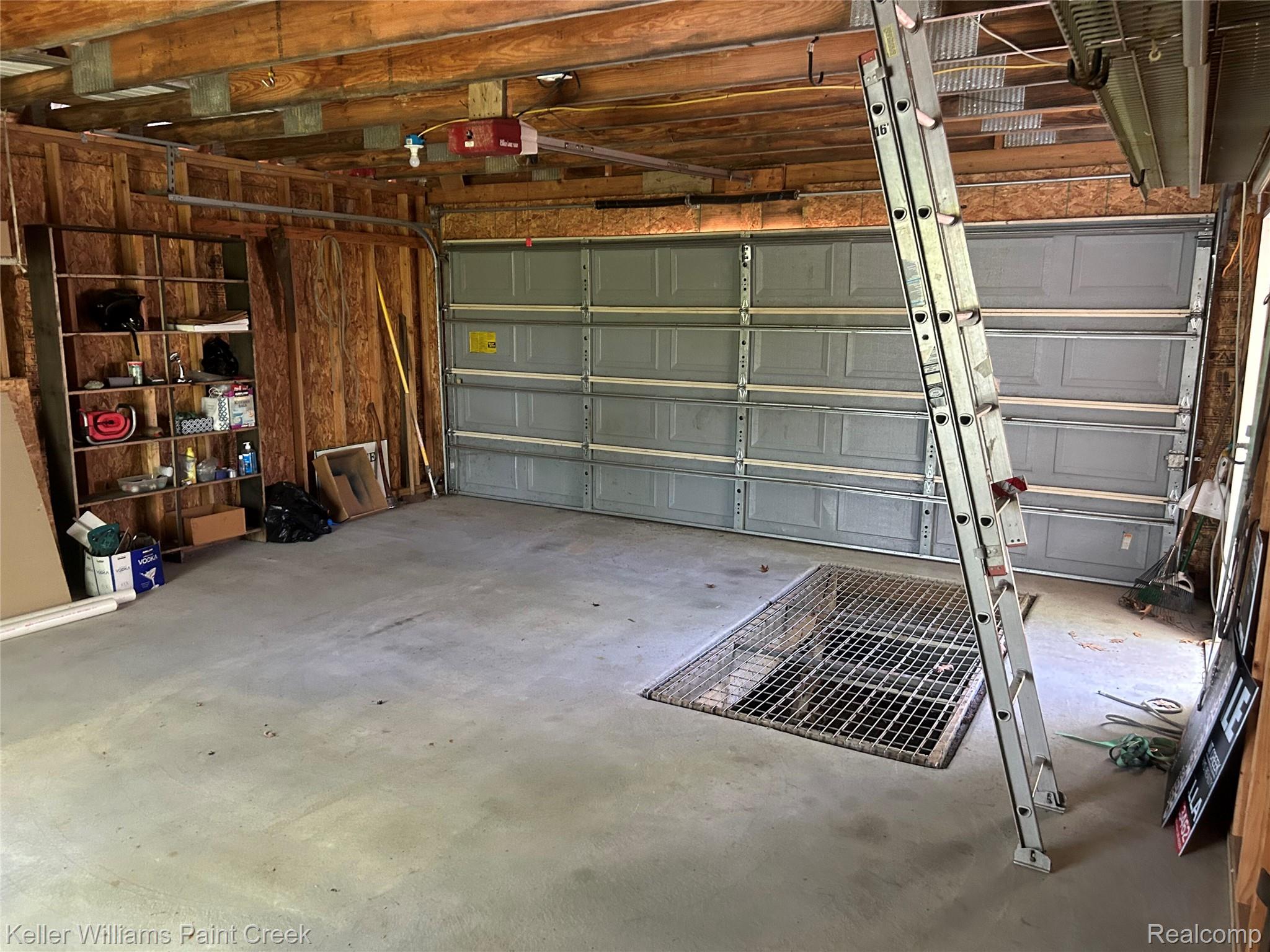 227 Ora Road Oxford, MI 48371 - Photo 56 of 60 Spacious garage featuring concrete flooring and exposed wood ceiling beams