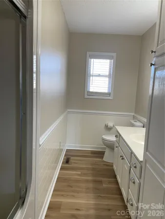 a view of a room with wooden floor and ceiling fan