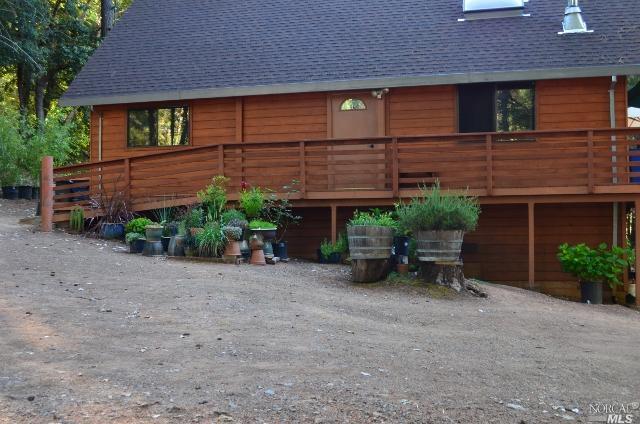 3851 Ridgewood Road Willits, CA 95490 - Photo 1 of 1 a view of a house with a yard and potted plants