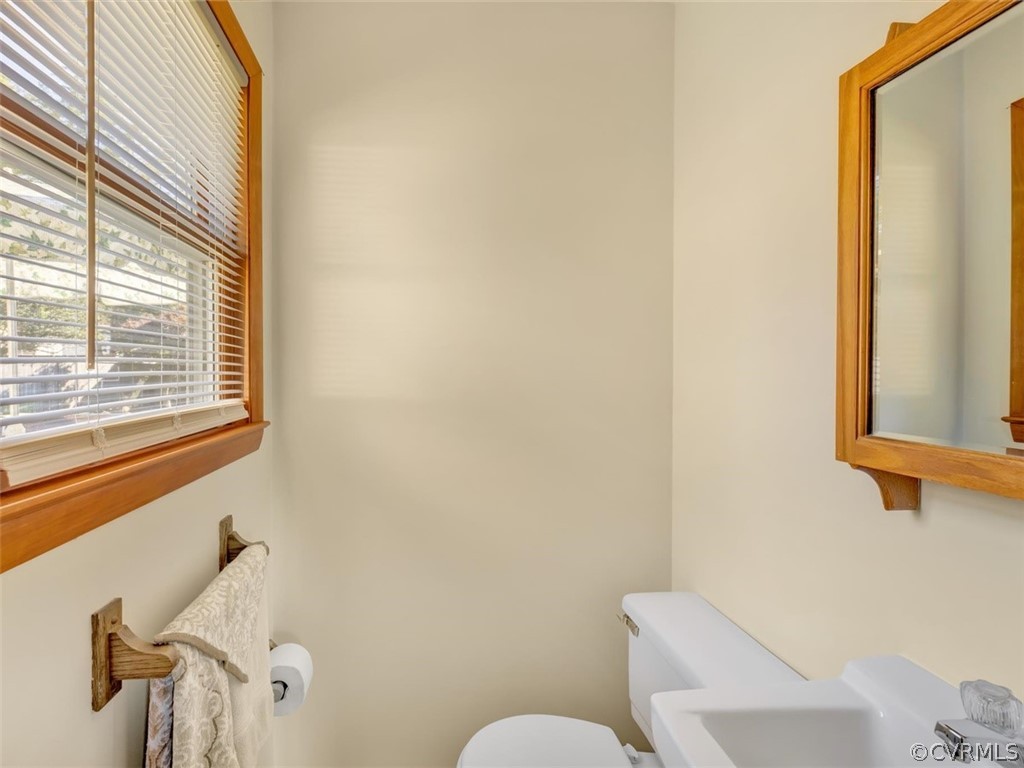 12020 Gardengate Road Midlothian, VA 23112 - Photo 17 of 25 a bathroom with a toilet sink and mirror