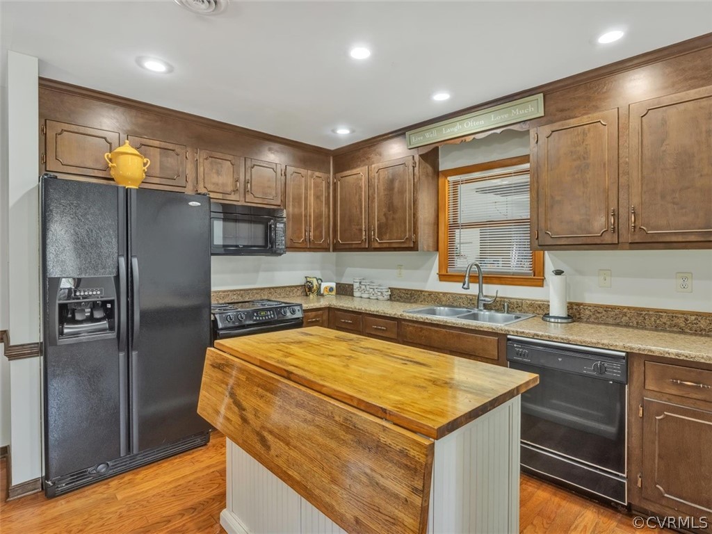 12020 Gardengate Road Midlothian, VA 23112 - Photo 8 of 25 a kitchen with a sink a refrigerator and cabinets