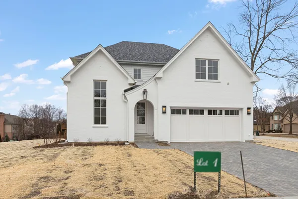 a view of a white house with a yard