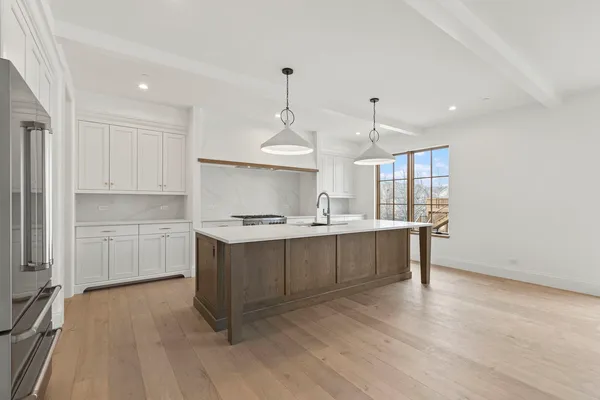 a kitchen with sink cabinets and wooden floor