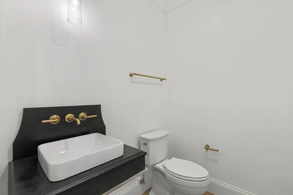 a white toilet sitting next to a white sink