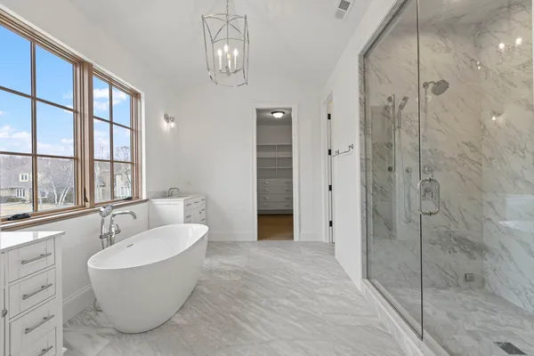 a bathroom with a tub and a shower