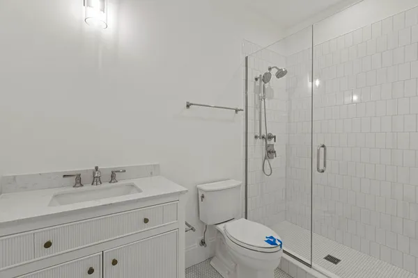 a bathroom with a sink toilet and shower