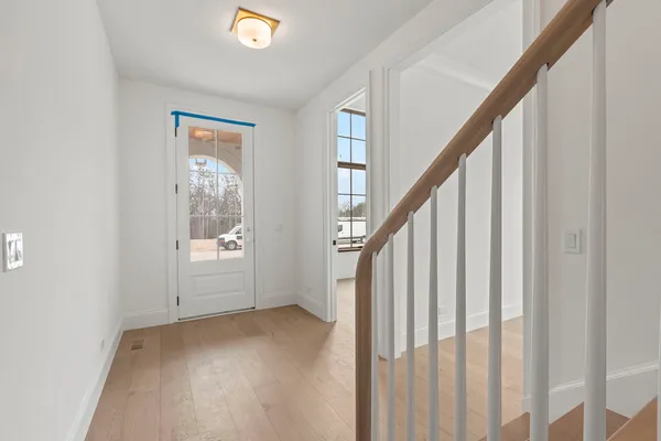 a view of entryway with wooden floor and stairs