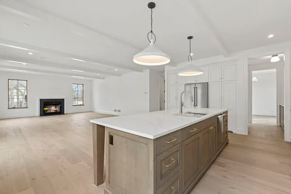 a view of living room kitchen with a sink and chandelier