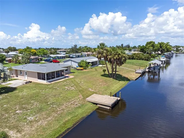 a view of a house with swimming pool and a yard