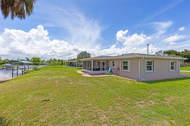 a view of a house with a yard and a garage