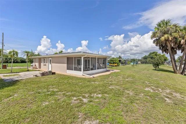 a front view of a house with a yard and lake view