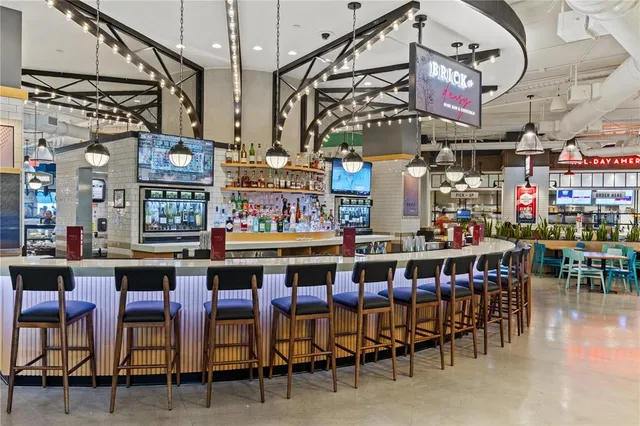 an aerial view of ocean with residential houses with outdoor space and seating