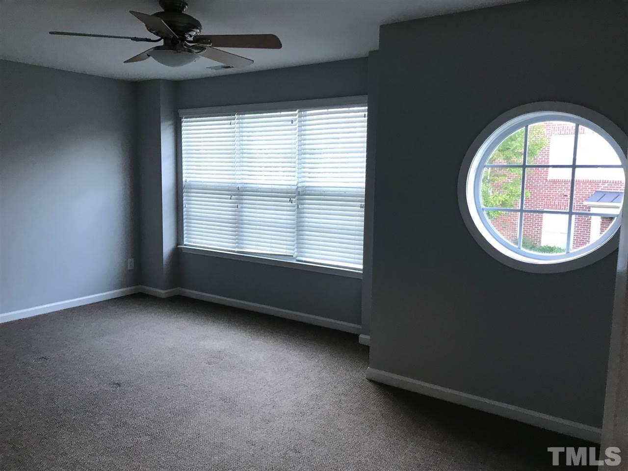 9904 Layla Avenue Raleigh, NC 27617 - Photo 12 of 19 an empty room with a window and a fan