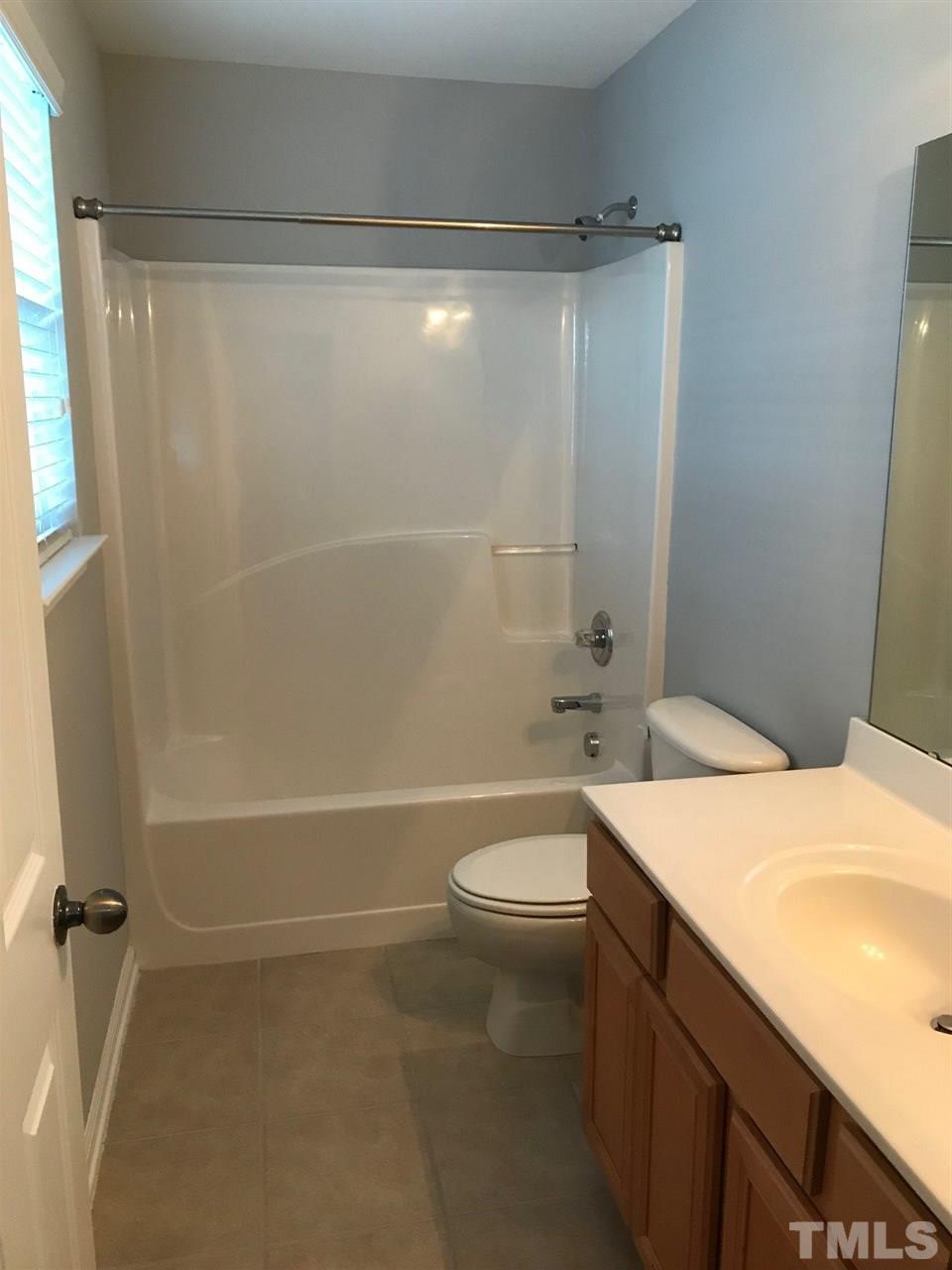 9904 Layla Avenue Raleigh, NC 27617 - Photo 16 of 19 a bathroom with a sink a toilet and shower