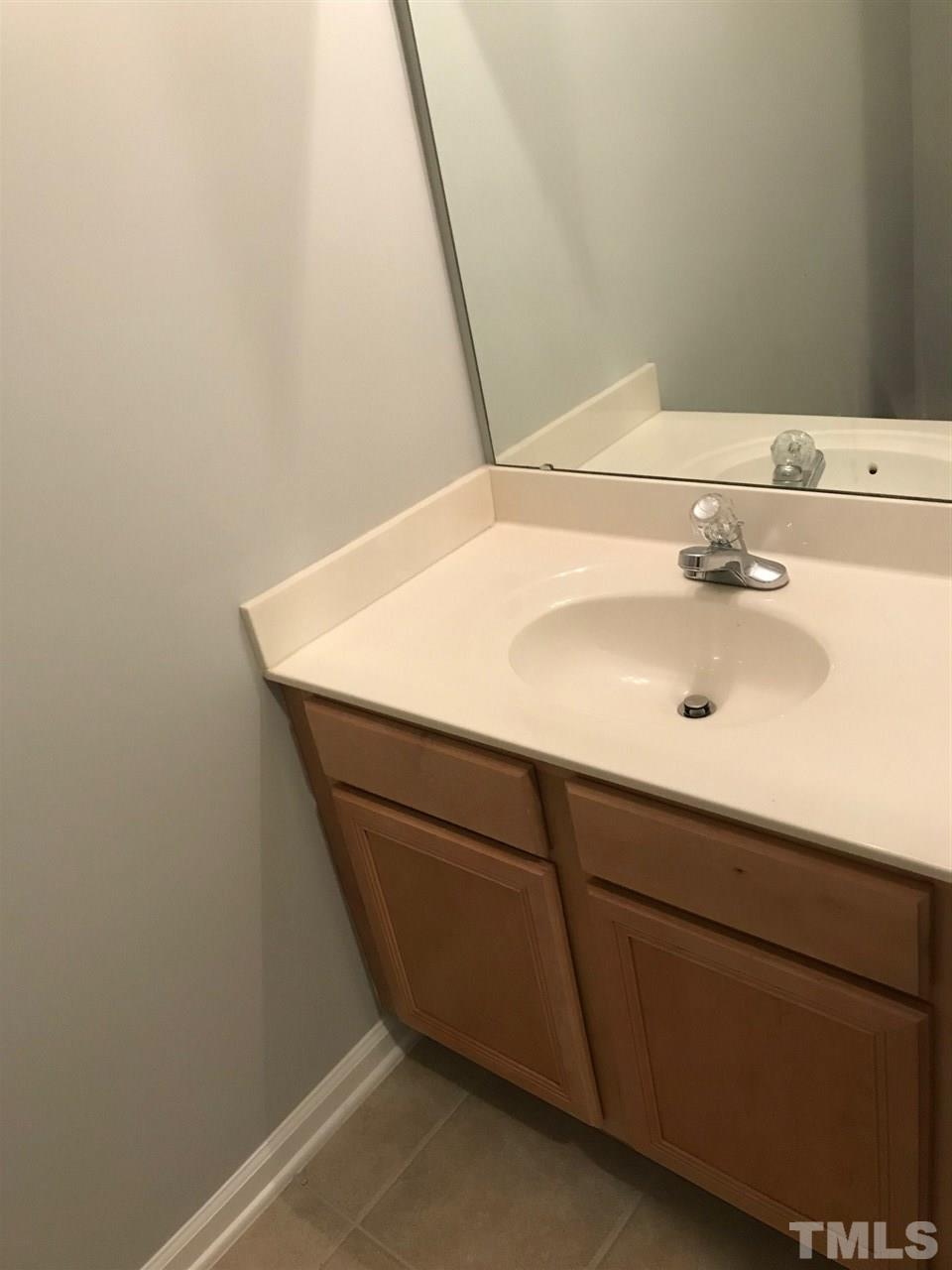 9904 Layla Avenue Raleigh, NC 27617 - Photo 17 of 19 a close up of a sink and a mirror