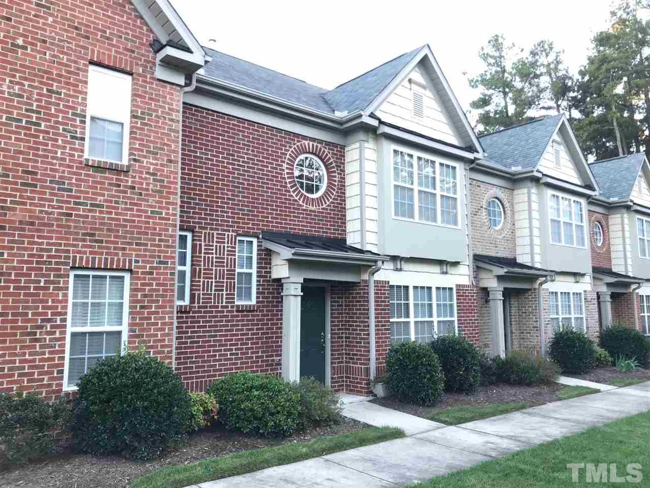 9904 Layla Avenue Raleigh, NC 27617 - Photo 3 of 19 a front view of a house with garden and garage