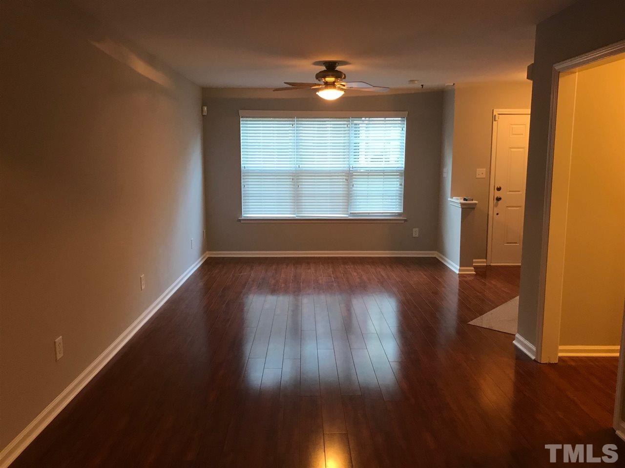 9904 Layla Avenue Raleigh, NC 27617 - Photo 7 of 19 an empty room with wooden floor and windows