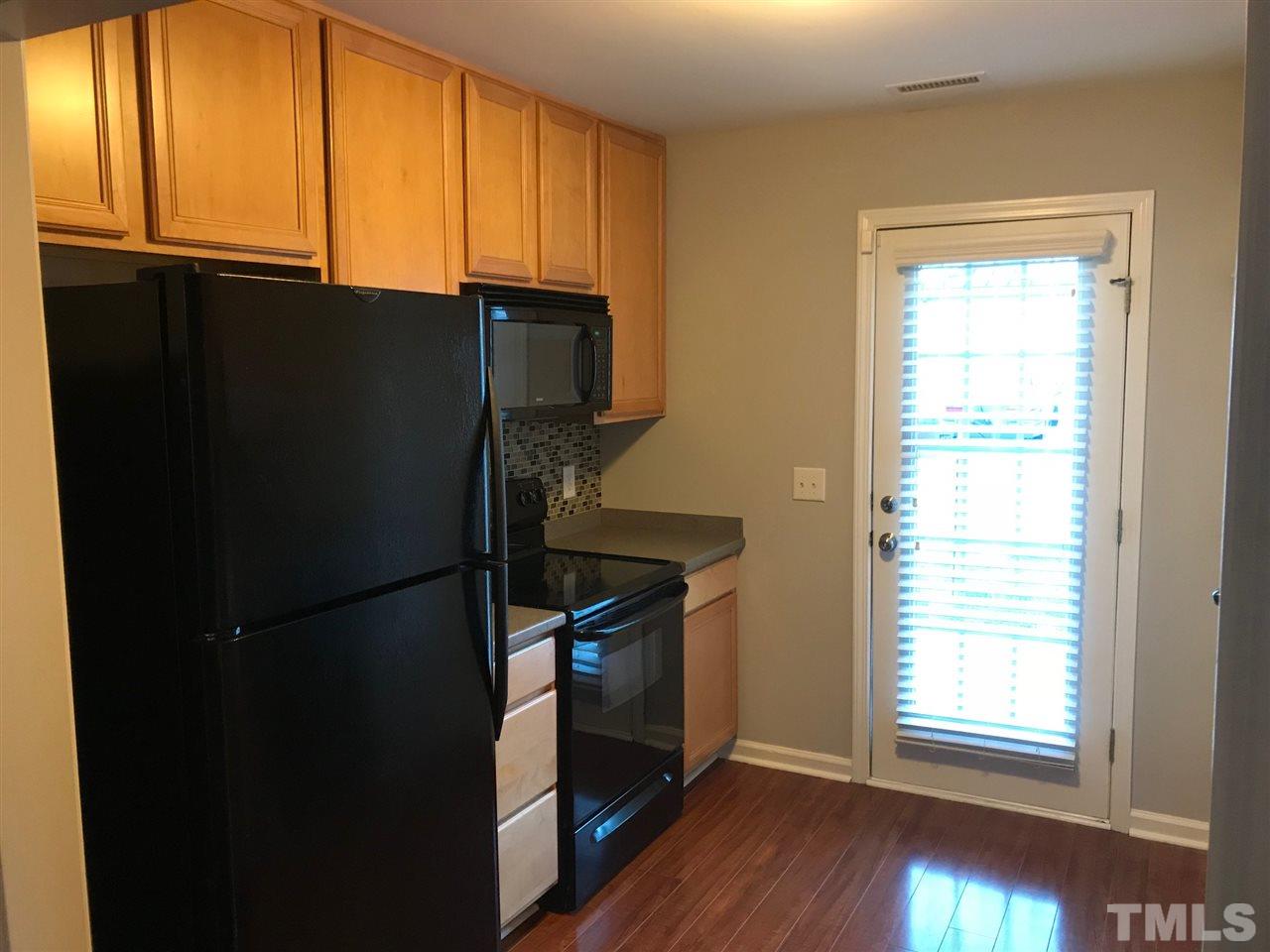 9904 Layla Avenue Raleigh, NC 27617 - Photo 10 of 19 a kitchen with windows and refrigerator