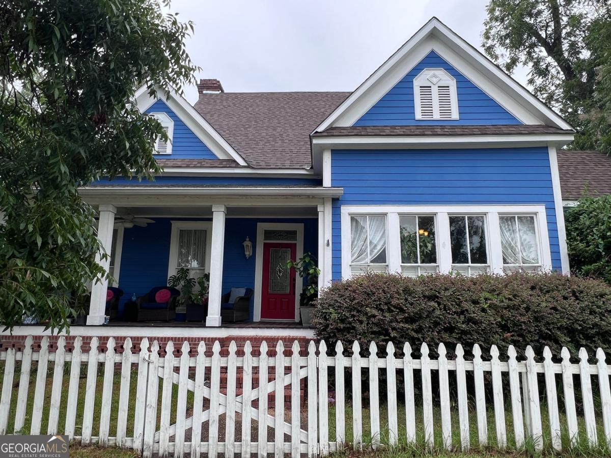 a view of a brick house with wooden fence