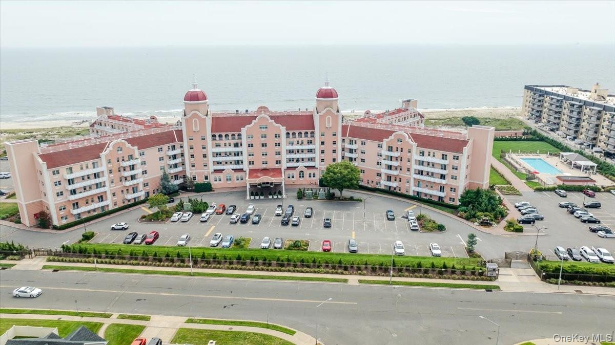 Bird's eye view of expansive coastline and apartment complex