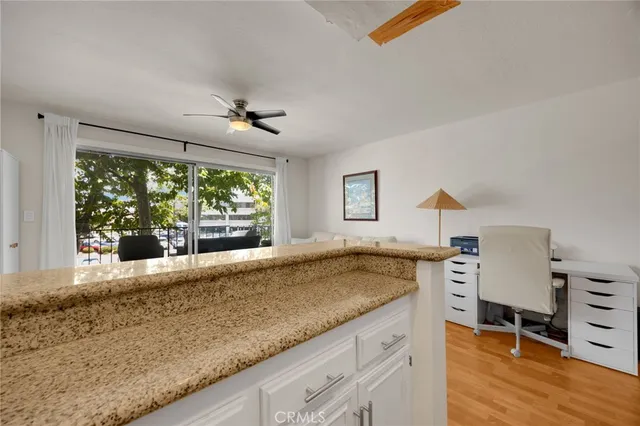 a spacious bathroom with a granite countertop sink and a window