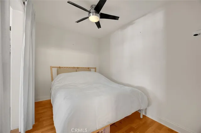 a bed room with a bed and a ceiling fan