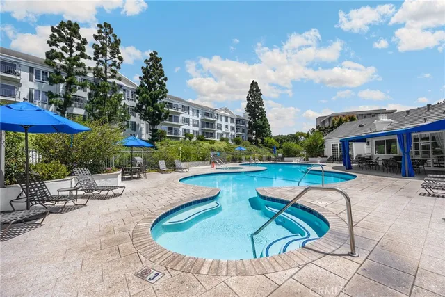 a view of a house with swimming pool and sitting area