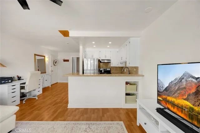 a living room with stainless steel appliances kitchen island granite countertop furniture and a kitchen view