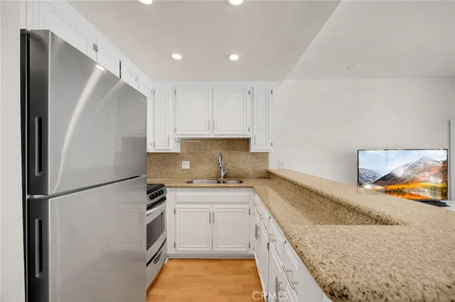 a kitchen with a sink a stove and refrigerator