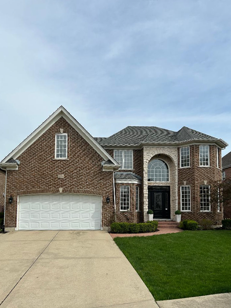 a front view of a house with a garden