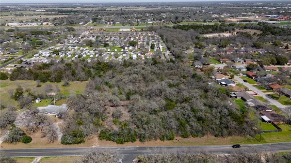 an aerial view of a houses with yard